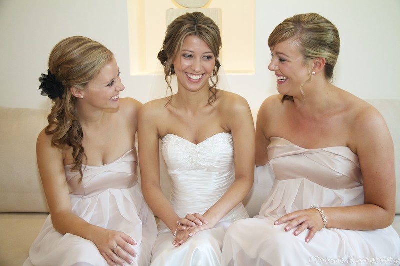 Bride and bridesmaids laughing - wedding photography